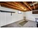 Unfinished basement area featuring an exposed ceiling and gray carpeting at 2226 Fulton St, Aurora, CO 80010