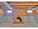 Basement area with exposed ceiling, brick fireplace, and built-in shelving at 2226 Fulton St, Aurora, CO 80010