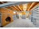 Finished basement featuring a brick fireplace, exposed ceiling, and gray carpet at 2226 Fulton St, Aurora, CO 80010