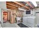 Spacious unfinished basement featuring a washer, dryer, and utility sink at 2226 Fulton St, Aurora, CO 80010