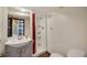 Bathroom with a stand-up shower, single sink vanity, and tile floors at 2226 Fulton St, Aurora, CO 80010