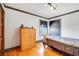 Comfortable bedroom with hardwood floors, natural light, and traditional wooden dresser at 2226 Fulton St, Aurora, CO 80010