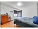 Comfortable bedroom featuring hardwood floors and ample natural light from the window at 2226 Fulton St, Aurora, CO 80010