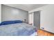 Stylish bedroom featuring hardwood floors, gray walls, and modern sliding barn door at 2226 Fulton St, Aurora, CO 80010