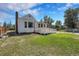 Exterior of house showing yard, chimney, wooden deck, and bay window at 2226 Fulton St, Aurora, CO 80010