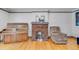 Inviting living room with brick fireplace, wood floors, piano and comfortable armchair at 2226 Fulton St, Aurora, CO 80010