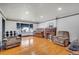 Spacious living room featuring a brick fireplace, hardwood floors, and bright natural light at 2226 Fulton St, Aurora, CO 80010