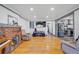 Open concept living room boasting hardwood floors, brick fireplace, and seamless flow to the kitchen at 2226 Fulton St, Aurora, CO 80010