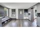 Open-concept living area with modern gray wood floors, two windows, and gray trim at 2226 Fulton St, Aurora, CO 80010