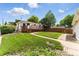 Well-kept backyard showcasing a small deck, lush lawn, and concrete walkway at 4505 W Gill Pl, Denver, CO 80219