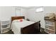 Bright bedroom with a white walls, with a wood frame bed, and two windows with blinds at 4505 W Gill Pl, Denver, CO 80219