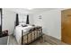 Bedroom featuring a wrought iron bed and dark curtains at 4505 W Gill Pl, Denver, CO 80219