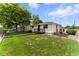 Home exterior with a green lawn, a charming side porch, and well-maintained landscaping at 4505 W Gill Pl, Denver, CO 80219