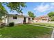 Charming home with a well-maintained lawn, sidewalk, and mature trees nearby at 4505 W Gill Pl, Denver, CO 80219