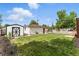 View of a white garage and shed with a green lawn, highlighting practical outdoor space at 4505 W Gill Pl, Denver, CO 80219
