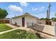 Garage with white siding, pink door, gated driveway, and a patch of grass at 4505 W Gill Pl, Denver, CO 80219