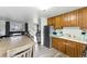 Eat-in kitchen with wood cabinets, stainless steel appliances, and an open concept at 4505 W Gill Pl, Denver, CO 80219