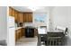 The Kitchen is well-lit and has a dining table nearby and wood cabinets at 4505 W Gill Pl, Denver, CO 80219