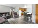 Open-concept floor plan featuring a living room with a dining area and kitchen nearby at 4505 W Gill Pl, Denver, CO 80219