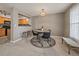 Cozy dining area features modern black chairs, a round wooden table, and an attractive jute rug creating a welcoming atmosphere at 12802 Jasmine St # B, Thornton, CO 80602