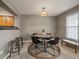 Cozy dining area with modern lighting and a view into the adjacent kitchen space at 12802 Jasmine St # B, Thornton, CO 80602