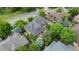 Aerial view of a home with mature trees and a well-maintained landscape in a residential neighborhood at 1313 Jade Ln, Longmont, CO 80504