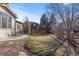 Backyard with a well-maintained lawn, mature trees, and a play structure for ' enjoyment at 1313 Jade Ln, Longmont, CO 80504