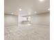 Finished basement with neutral carpet and paint, recessed lighting, partial kitchen at 1313 Jade Ln, Longmont, CO 80504