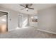 Bedroom featuring soft carpet flooring, a ceiling fan, a large window, and doorway leading to another room at 1313 Jade Ln, Longmont, CO 80504