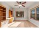 Bedroom with hardwood floors, ceiling fan, a built in desk, and a window at 1313 Jade Ln, Longmont, CO 80504