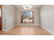 Elegant dining room with hardwood floors, a chandelier, and a scenic window view at 1313 Jade Ln, Longmont, CO 80504