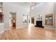 Open-concept living space with hardwood floors, connecting to the kitchen and featuring a fireplace at 1313 Jade Ln, Longmont, CO 80504