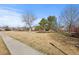 View of a community park with mature trees and a walking path, perfect for outdoor activities at 1313 Jade Ln, Longmont, CO 80504