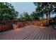 Beautiful deck with wooden railings, atmospheric lighting, and a view of the backyard at 16291 E 7Th Dr, Aurora, CO 80011