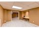 Open basement area with neutral carpet and walls plus a small built in desk at 16291 E 7Th Dr, Aurora, CO 80011