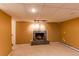 Finished basement with a cozy fireplace, carpet flooring, and a drop ceiling at 16291 E 7Th Dr, Aurora, CO 80011