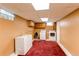 Unfinished basement area with laundry, storage, and neutral walls at 16291 E 7Th Dr, Aurora, CO 80011