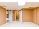 Finished basement with carpeted floor, baseboard heat, closet, and access to another room at 16291 E 7Th Dr, Aurora, CO 80011