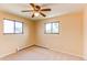Bedroom featuring yellow walls, neutral carpet, and a window at 16291 E 7Th Dr, Aurora, CO 80011