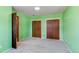 Spacious bedroom featuring green walls, neutral carpet, and double closets at 16291 E 7Th Dr, Aurora, CO 80011