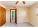 Bedroom featuring yellow walls, neutral carpet, and a window, with a connecting room at 16291 E 7Th Dr, Aurora, CO 80011