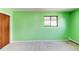 Bedroom featuring green walls, light carpet, and a window at 16291 E 7Th Dr, Aurora, CO 80011