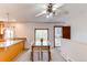 Cozy dining area with a wooden table, white chairs, ceiling fan, and large window at 16291 E 7Th Dr, Aurora, CO 80011