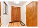 Bright entryway with hardwood floors, coat closet, and modern finishes at 16291 E 7Th Dr, Aurora, CO 80011