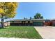 Charming ranch-style home with a well-manicured lawn, brick accents, and an attached garage at 16291 E 7Th Dr, Aurora, CO 80011