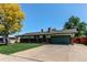 Charming single-story home with attached garage, mature trees, and well-kept front yard at 16291 E 7Th Dr, Aurora, CO 80011