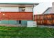 Well-maintained exterior of house with green lawn, brick accents, and Generac generator at 16291 E 7Th Dr, Aurora, CO 80011