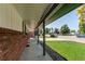 Spacious covered porch perfect for relaxing and enjoying the beautifully landscaped yard at 16291 E 7Th Dr, Aurora, CO 80011