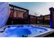 Relaxing hot tub with a wooden deck and view of the home's back exterior at 16291 E 7Th Dr, Aurora, CO 80011