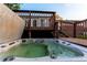 Backyard deck featuring a large hot tub with ample seating at 16291 E 7Th Dr, Aurora, CO 80011